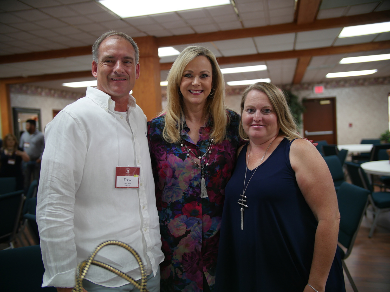 Jane Hamon takes a picture with members of the CI Apostolic Network